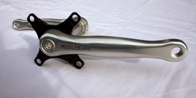 Photo of a set of Silver Middleburn cranks not attached to a bike with a black 4 pin spider