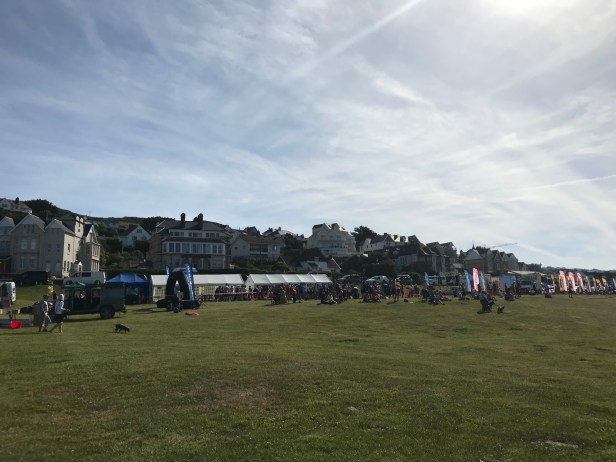 Photo of a finish line field with tents and runners