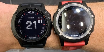 Two Garmin Fenix watches side-by-side on a wrist